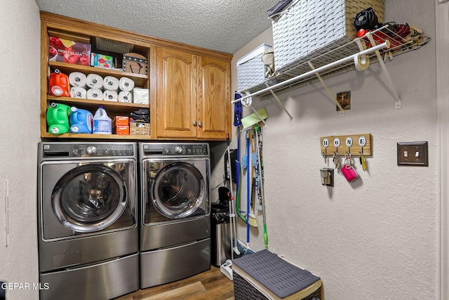 11179 Leo Collins Dr, El Paso, TX 79936 - laundry area with independent washer and dryer, wood finished floors, cabinet space, a textured wall, and a textured ceiling