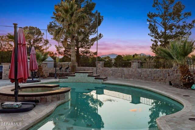11179 Leo Collins Dr, El Paso, TX 79936 - pool at dusk with a pool with connected hot tub