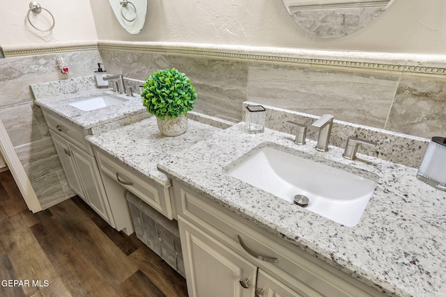 11179 Leo Collins Dr, El Paso, TX 79936 - bathroom with vanity, tile walls, wood finished floors, backsplash, and a textured wall