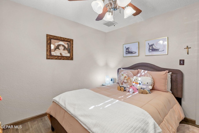 11179 Leo Collins Dr, El Paso, TX 79936 - bedroom with wood finished floors and a ceiling fan
