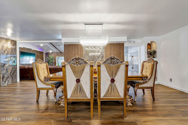 11179 Leo Collins Dr, El Paso, TX 79936 - dining room with a chandelier, wood finished floors, and baseboards