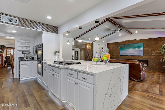 11179 Leo Collins Dr, El Paso, TX 79936 - kitchen with stainless steel gas cooktop, white cabinets, wood finished floors, light stone counters, and recessed lighting