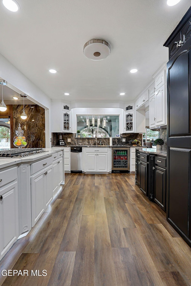 11179 Leo Collins Dr, El Paso, TX 79936 - kitchen featuring stainless steel appliances, white cabinets, tasteful backsplash, wine cooler, and recessed lighting