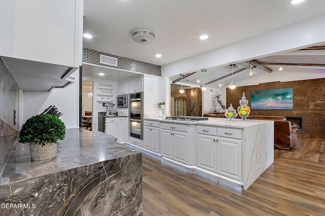 11179 Leo Collins Dr, El Paso, TX 79936 - kitchen with dark wood-type flooring, a peninsula, appliances with stainless steel finishes, white cabinets, and recessed lighting
