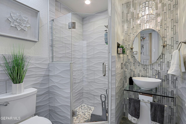 11179 Leo Collins Dr, El Paso, TX 79936 - bathroom with tile walls, toilet, a shower stall, a chandelier, and vanity