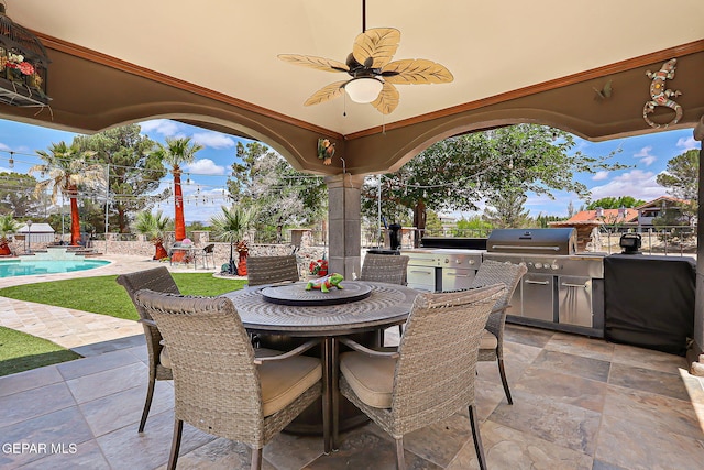 11179 Leo Collins Dr, El Paso, TX 79936 - view of patio with exterior kitchen, a fenced backyard, outdoor dining area, ceiling fan, and area for grilling
