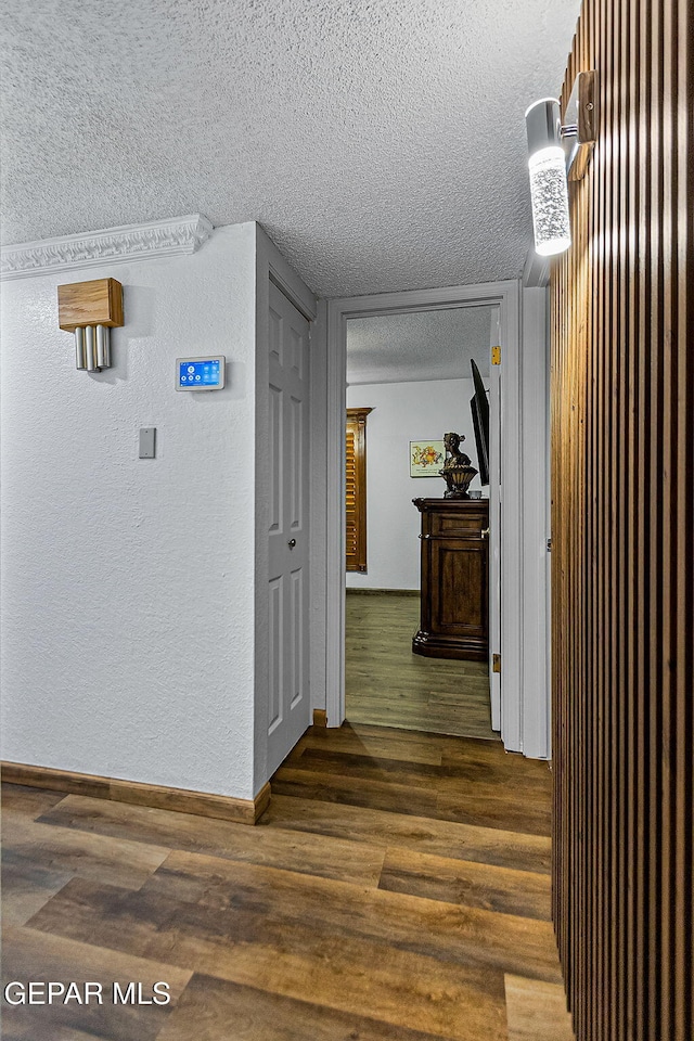 11179 Leo Collins Dr, El Paso, TX 79936 - corridor featuring a textured ceiling, dark wood-type flooring, and baseboards