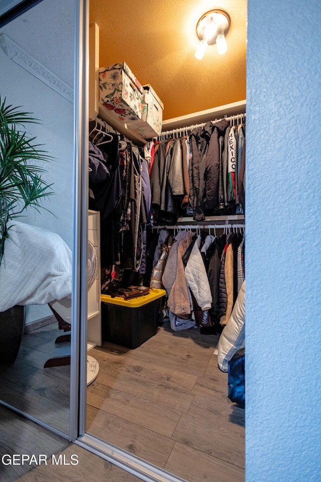 11179 Leo Collins Dr, El Paso, TX 79936 - walk in closet with wood finished floors