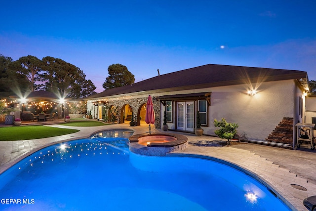 11179 Leo Collins Dr, El Paso, TX 79936 - pool at dusk with french doors, a patio, and a pool with connected hot tub