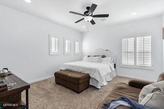 carpeted bedroom featuring multiple windows and ceiling fan