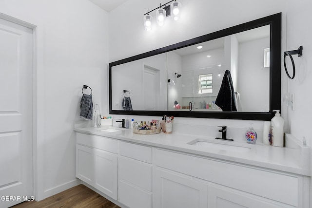 bathroom featuring vanity, wood-type flooring, and an enclosed shower