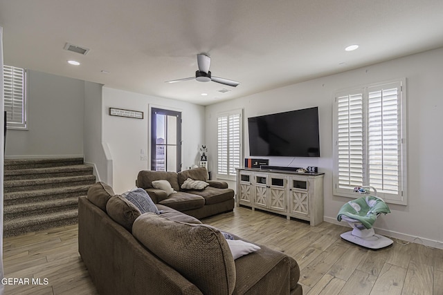 living room featuring light hardwood / wood-style floors and ceiling fan