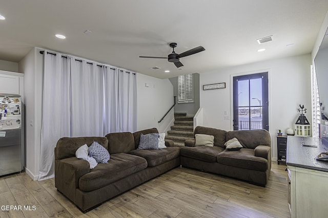 living room featuring light hardwood / wood-style flooring and ceiling fan