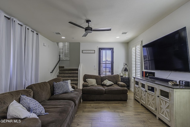 living room with ceiling fan and light hardwood / wood-style flooring