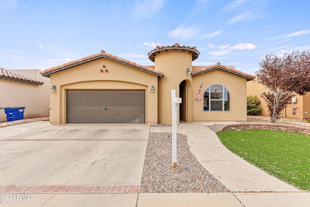 mediterranean / spanish-style house featuring a front yard and a garage