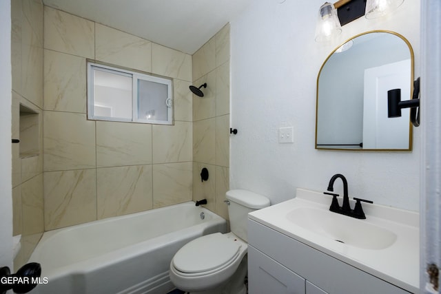 full bathroom featuring tiled shower / bath, vanity, and toilet