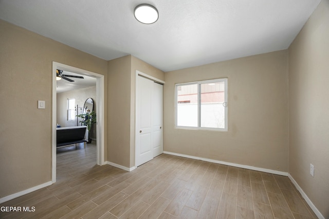 unfurnished bedroom featuring light hardwood / wood-style floors and a closet