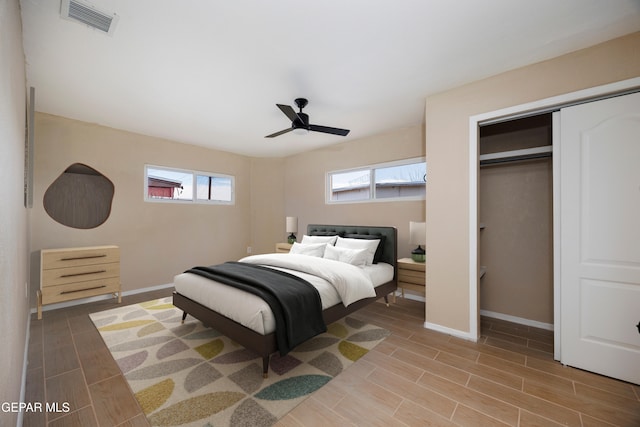 bedroom with hardwood / wood-style floors, ceiling fan, and a closet