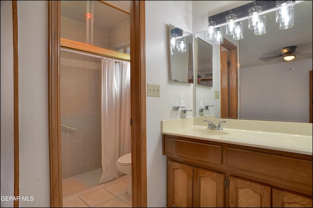 bathroom featuring vanity, tile patterned floors, a shower with shower curtain, ceiling fan, and toilet