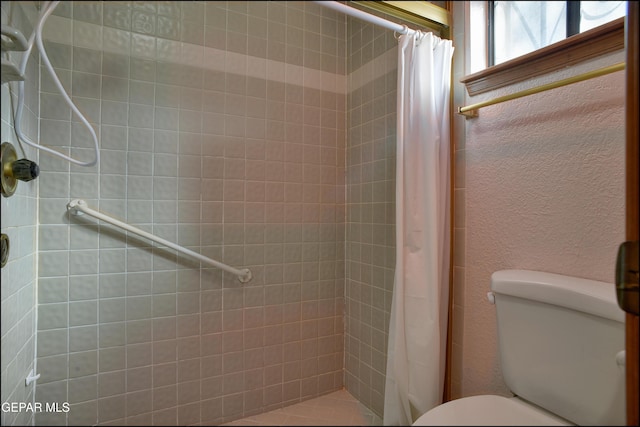 bathroom with walk in shower and toilet