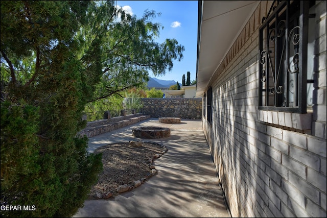 view of patio / terrace featuring a mountain view and an outdoor fire pit