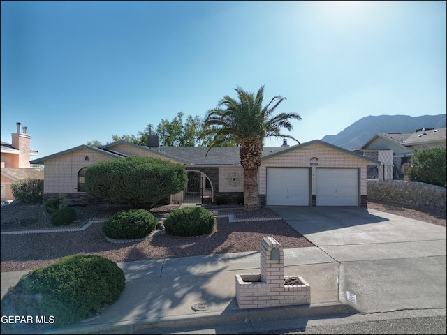 ranch-style home with a mountain view and a garage