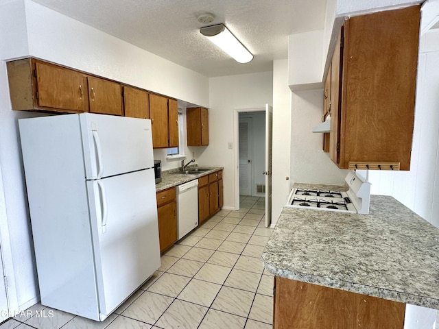 kitchen featuring sink, white appliances, a textured ceiling, and extractor fan