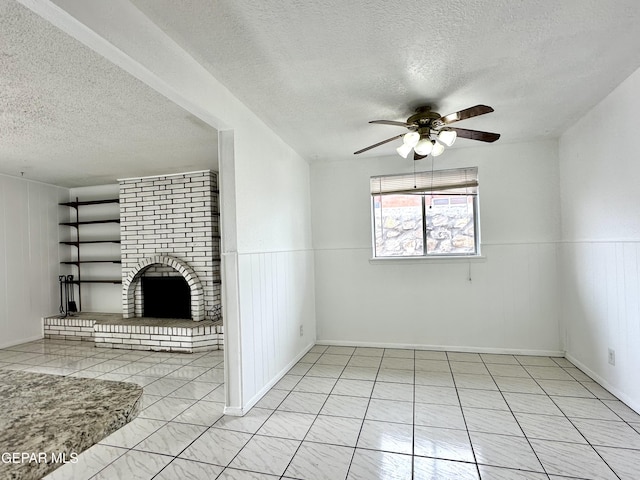 unfurnished living room with a fireplace, a textured ceiling, and ceiling fan