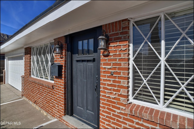 view of exterior entry with a garage