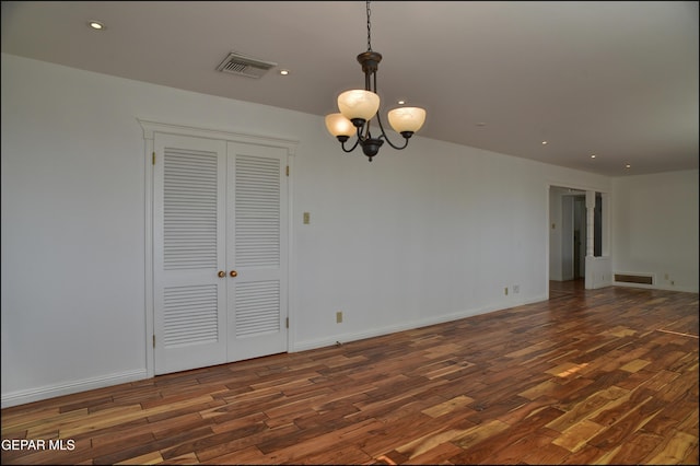 interior space featuring dark hardwood / wood-style floors and an inviting chandelier