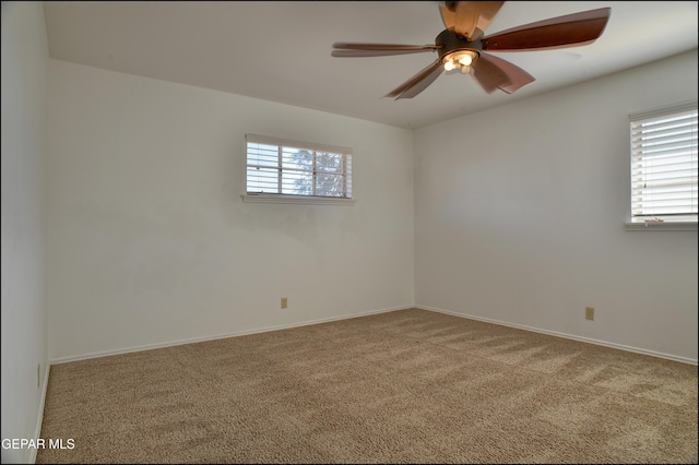 spare room featuring carpet, ceiling fan, and a healthy amount of sunlight