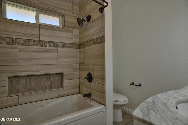 bathroom with tiled shower / bath combo and toilet