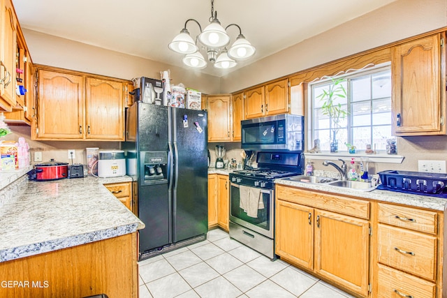 kitchen with an inviting chandelier, sink, light tile patterned floors, appliances with stainless steel finishes, and decorative light fixtures