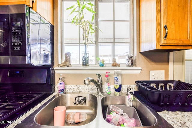 interior details with light stone counters and sink