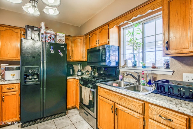 kitchen with sink, light tile patterned flooring, and stainless steel appliances