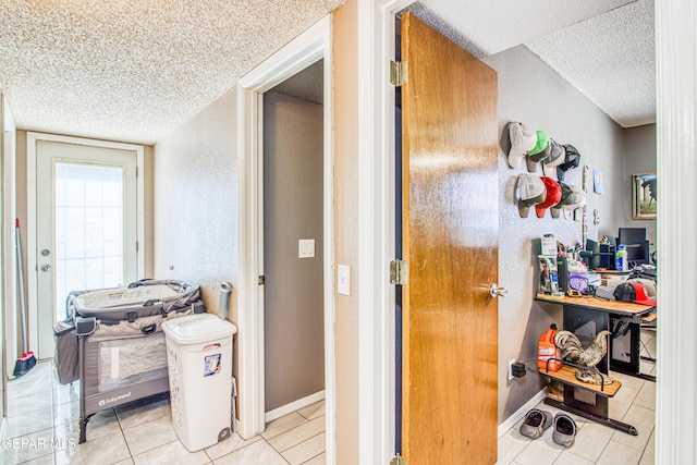 interior space with a textured ceiling and tile patterned floors