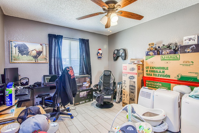 office featuring a textured ceiling and ceiling fan