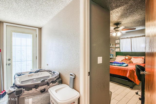 bathroom featuring ceiling fan and a textured ceiling