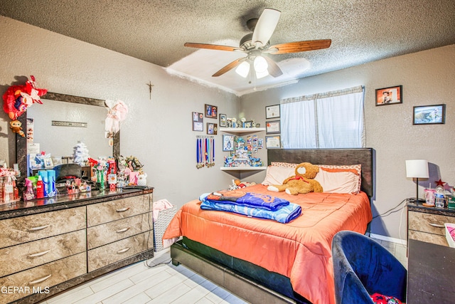 bedroom with a textured ceiling and ceiling fan