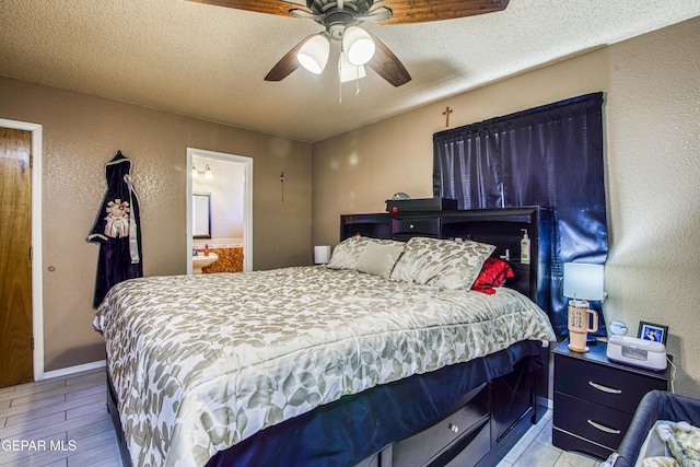 bedroom featuring ceiling fan, light hardwood / wood-style floors, a textured ceiling, and connected bathroom