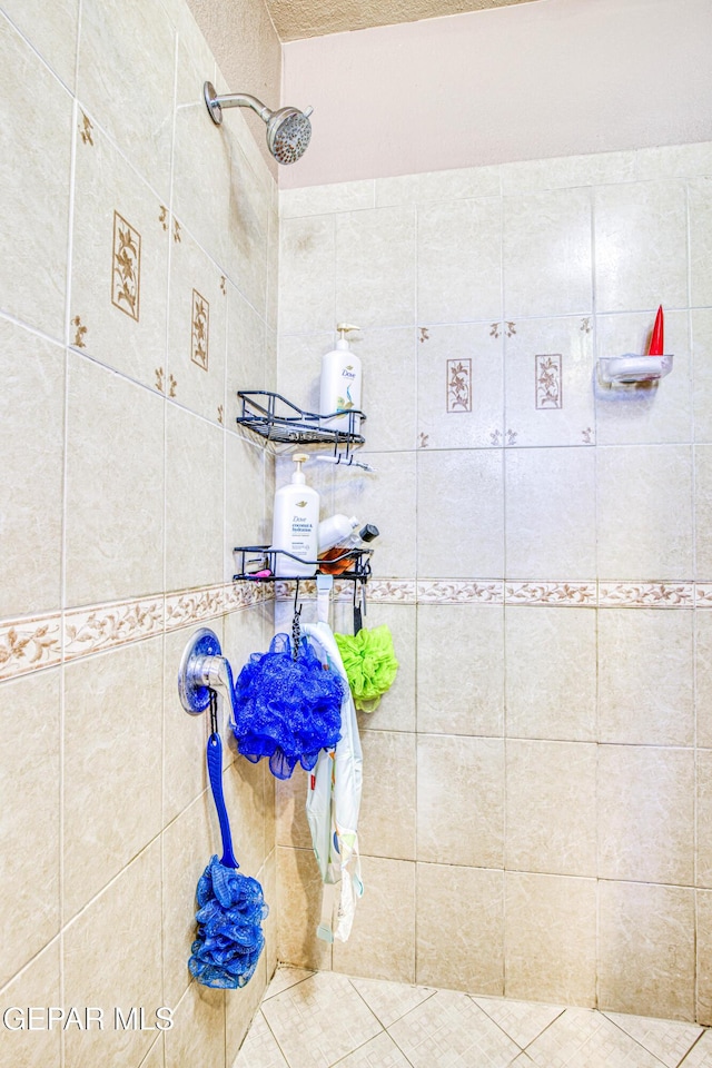 bathroom featuring tile patterned floors and tiled shower