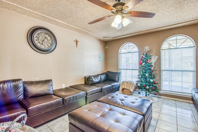 tiled living room with a textured ceiling and ceiling fan