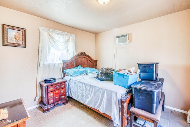 bedroom featuring a wall mounted AC