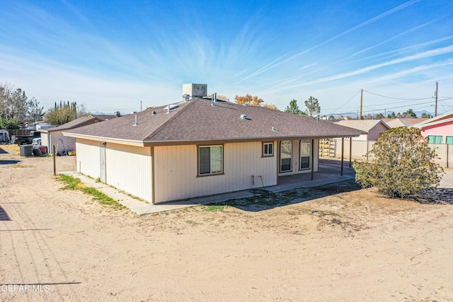 rear view of house with a patio and cooling unit