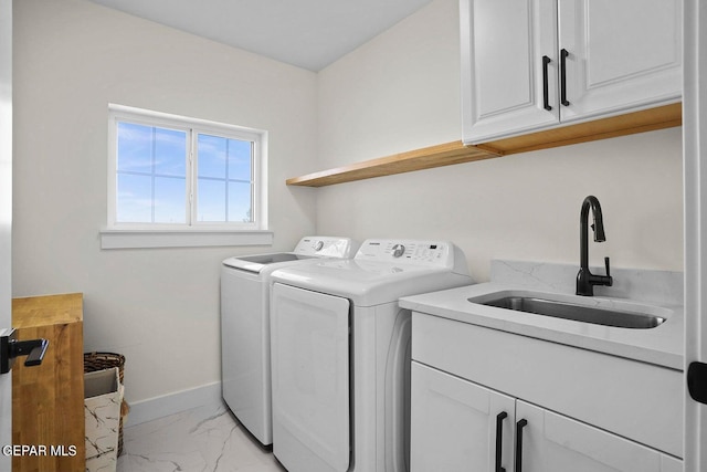 laundry room featuring sink, cabinets, and independent washer and dryer