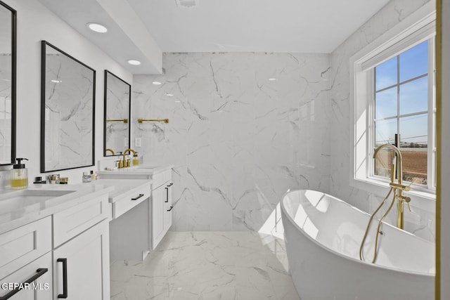 bathroom featuring a bathing tub and vanity