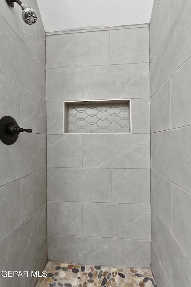 bathroom with tiled shower