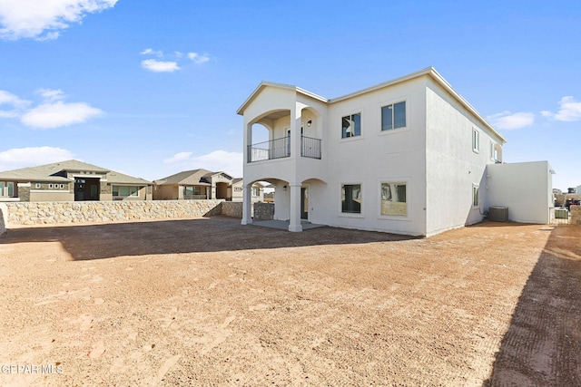 back of property featuring central AC and a balcony