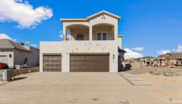 view of front of property featuring a balcony and a garage