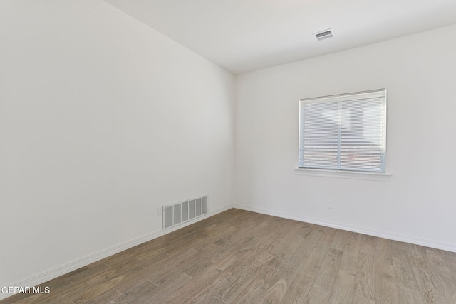 spare room with light hardwood / wood-style flooring